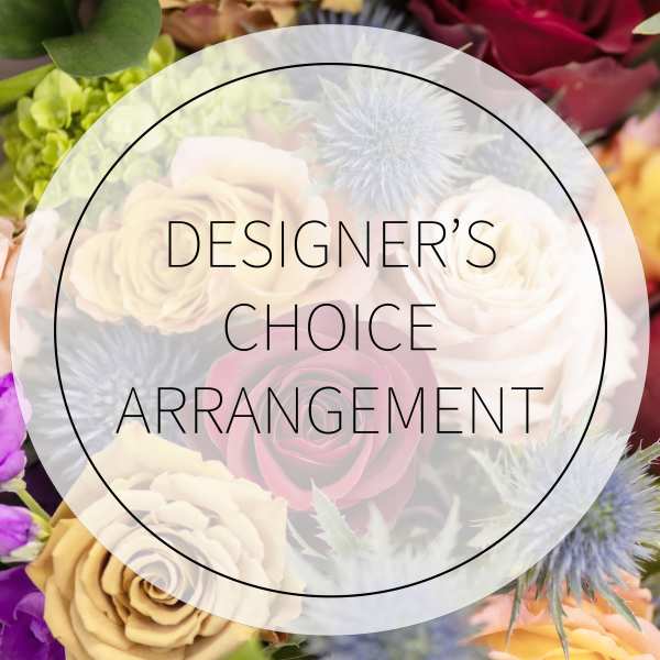 Designer’s choice floral arrangement with roses and thistle-like blooms