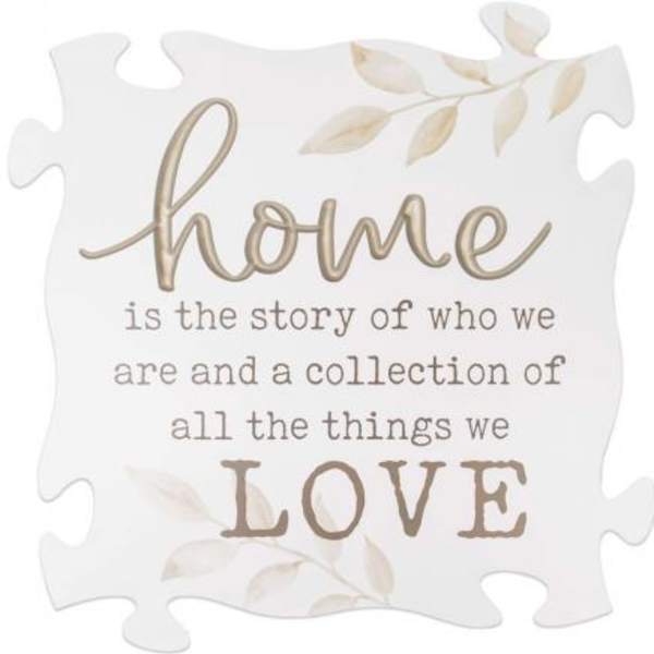 Decorative puzzle-piece sign with the word home and a love quote