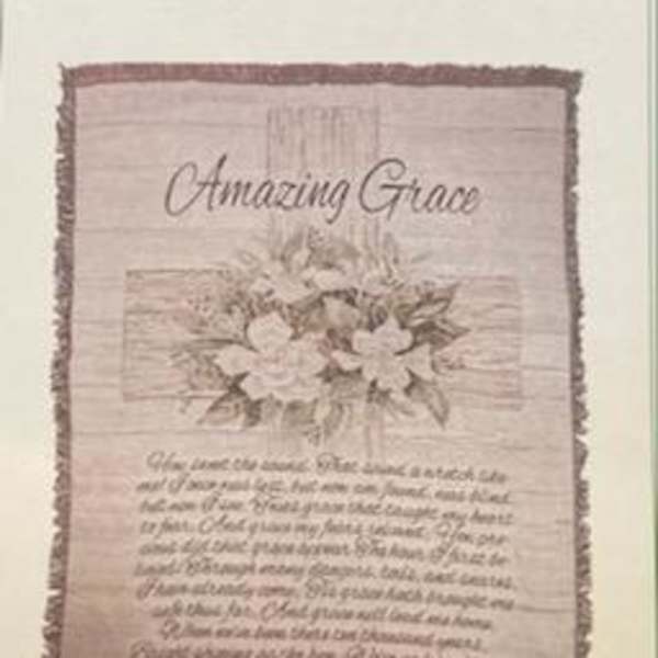 Framed wall hanging with the words "Amazing Grace" and floral artwork