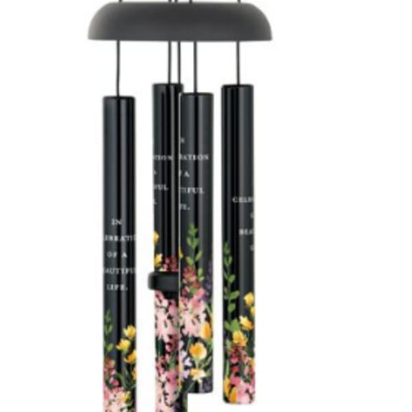 Black hanging wind chime with floral-printed tubes and a clapper