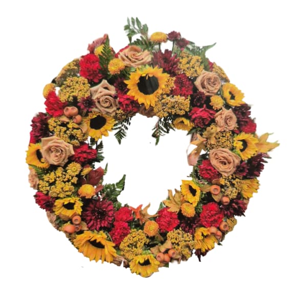 Circular wreath of sunflowers, roses, and red blooms