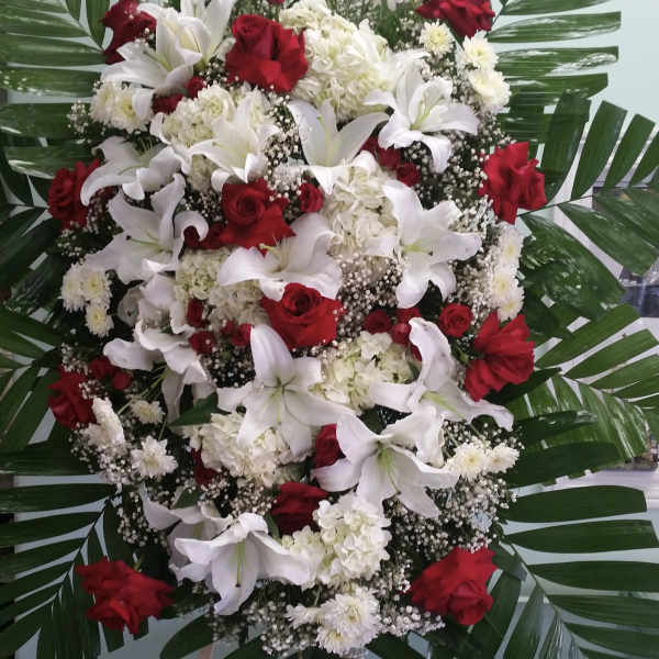 Large standing floral spray with red roses and white lilies