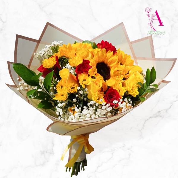 Bouquet of yellow sunflowers and red roses wrapped in translucent paper