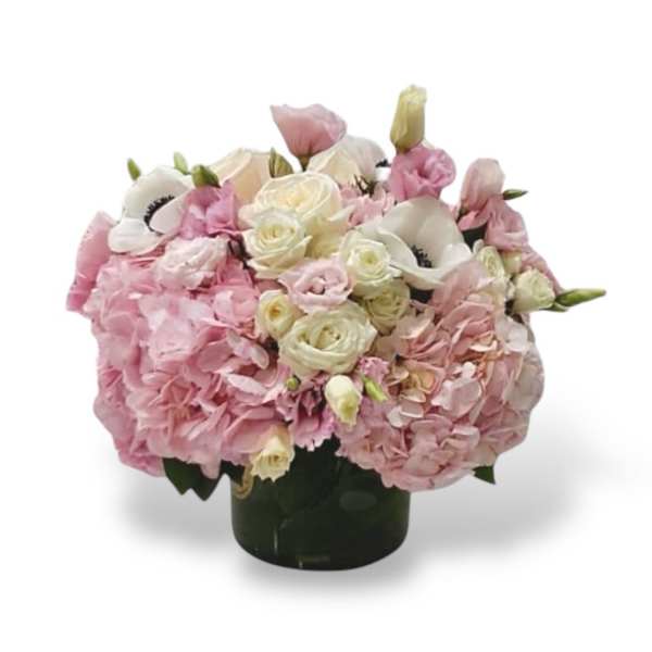 Pink and white floral arrangement in a dark vase
