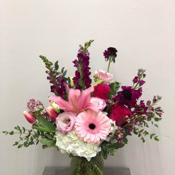Pink and purple mixed bouquet in a glass vase