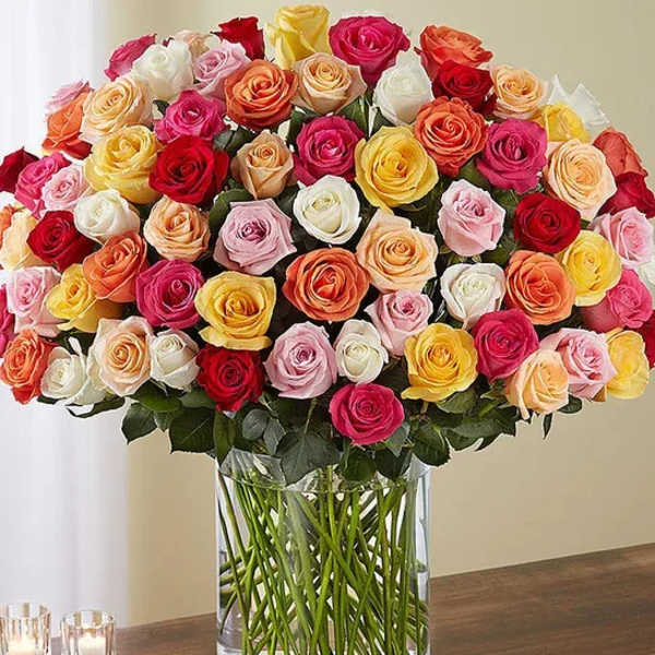 Large bouquet of multicolored roses in a clear glass vase