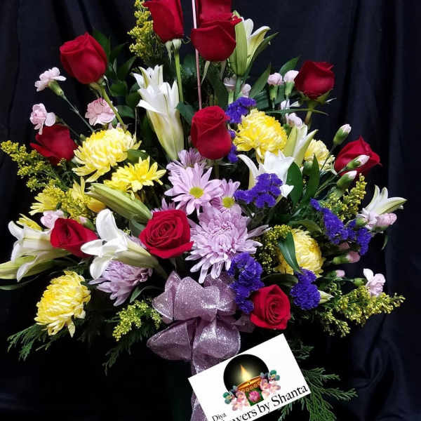Bouquet of red roses, white lilies, and mixed blooms with a Mother's Day topper