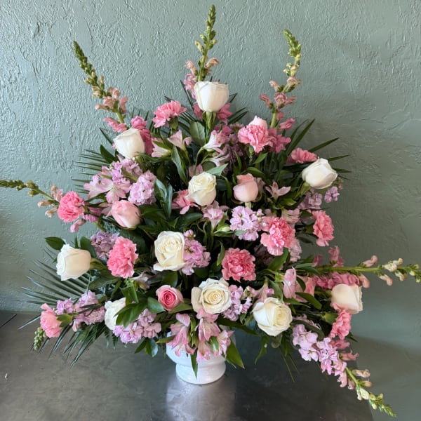 Pink and white floral arrangement in a white vase