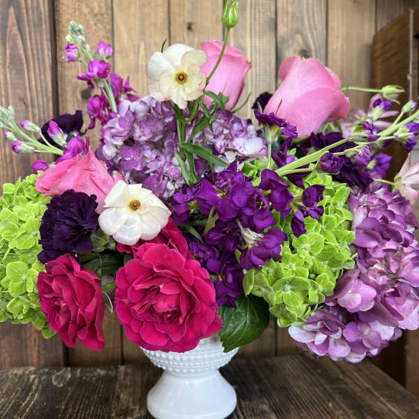 Pink and purple bouquet in a white vase