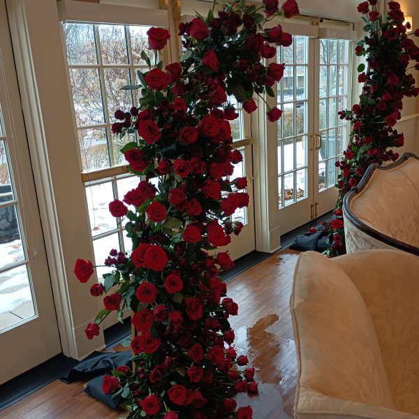 Tall columns of red roses arranged indoors