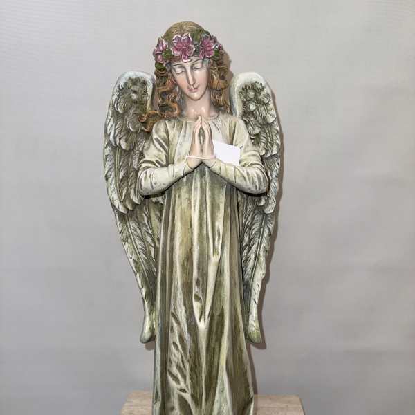 Decorative angel statue with floral crown and folded hands