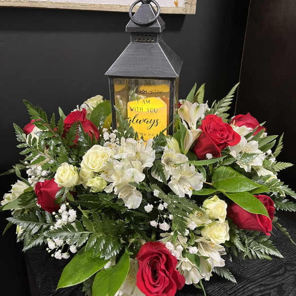Red and white rose arrangement with a lantern centerpiece