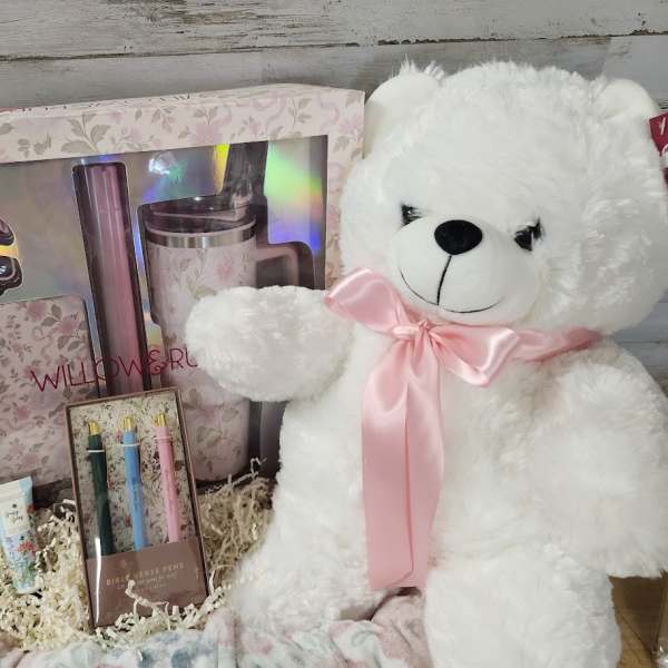 Gift basket with a teddy bear, boxed tumbler set, and pens