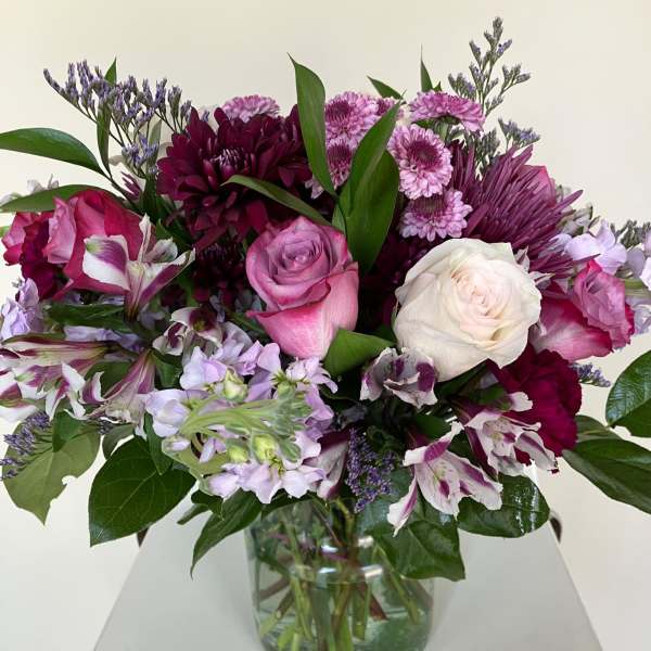 Pink, white, and purple bouquet in a glass vase