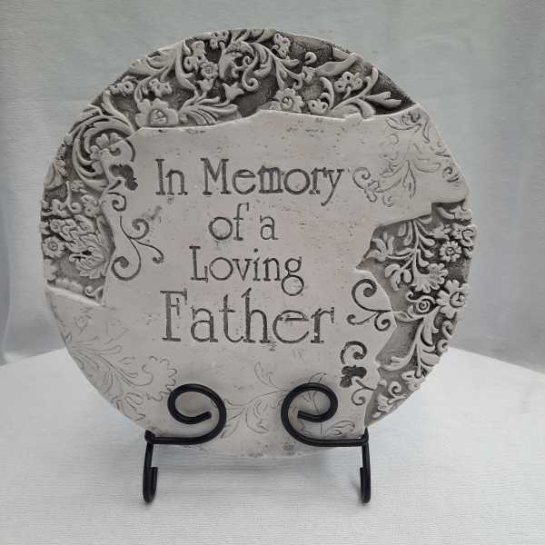 Decorative memorial plaque reading "In Memory of a Loving Father" on a stand