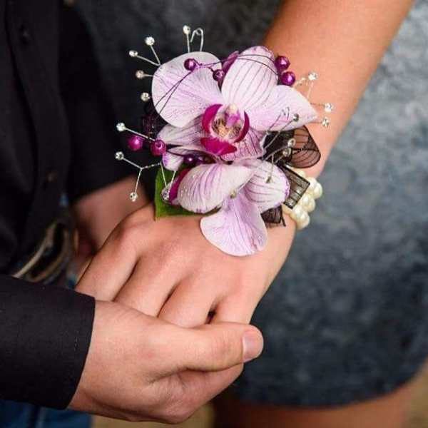 Purple orchid wrist corsage with pearl accents