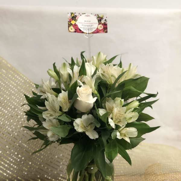 White roses and alstroemeria in a glass vase