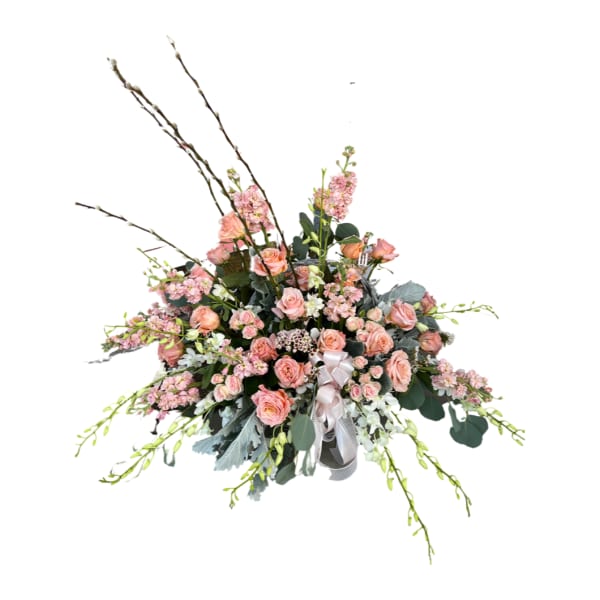 Large pink rose arrangement with tall branches and a ribbon bow