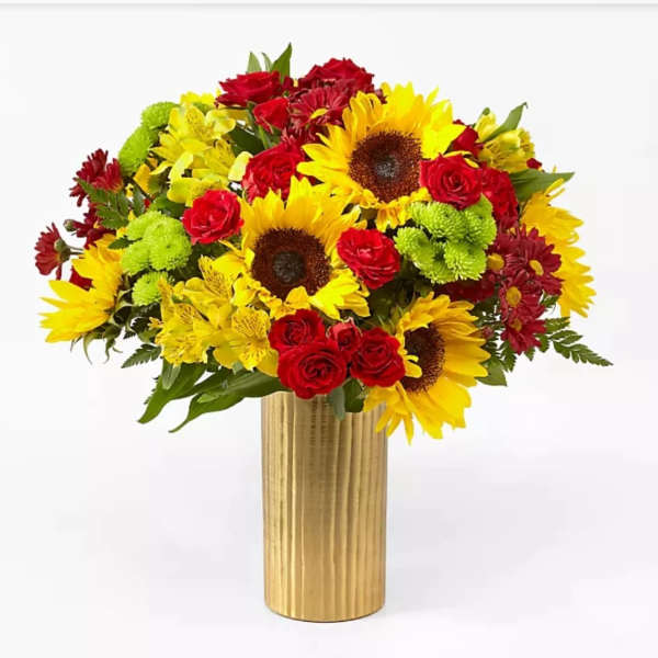 Bouquet of sunflowers, red roses, and yellow flowers in a gold vase