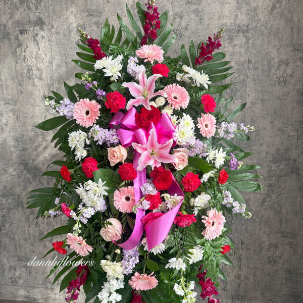 Standing floral spray with pink lilies, roses, and gerbera daisies