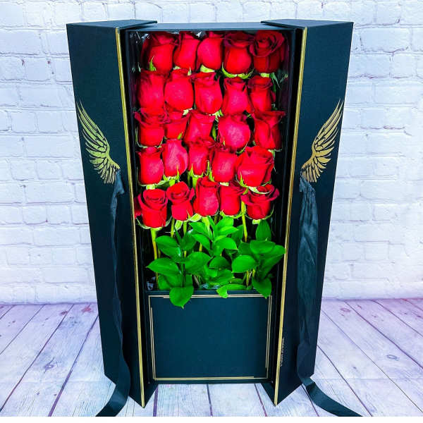 Boxed arrangement of red roses in a black gift box