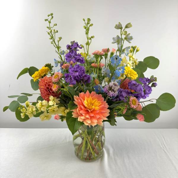 Mixed bouquet of colorful flowers in a clear glass vase