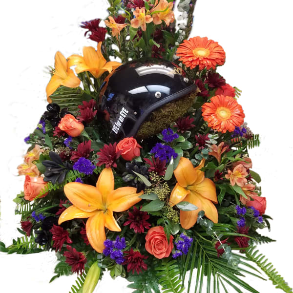 Floral arrangement with a black motorcycle helmet in the center