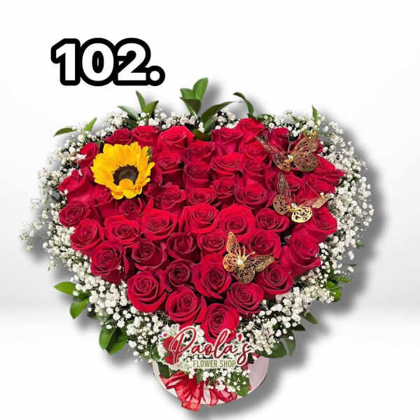 Heart-shaped bouquet of red roses with white baby's breath and a yellow sunflower