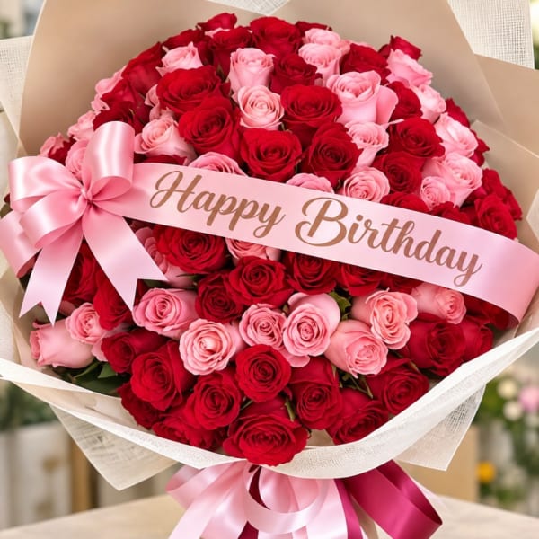 Bouquet of red and pink roses with a pink Happy Birthday ribbon