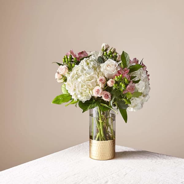 Bouquet of white and pale pink flowers in a glass vase