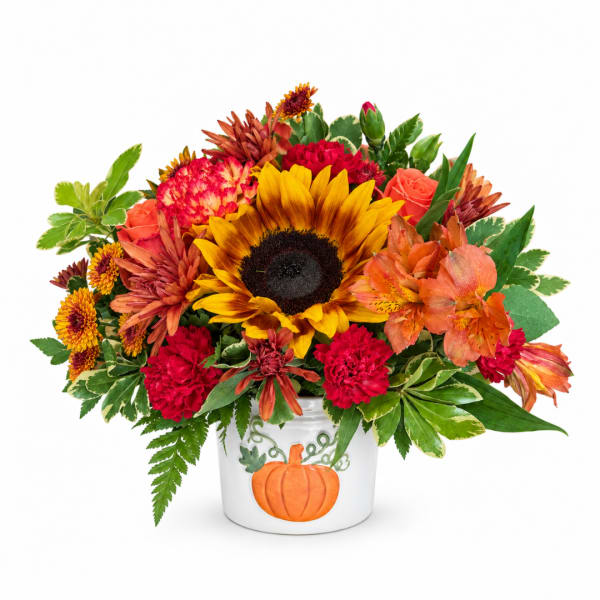 Fall bouquet in a white pumpkin vase with sunflowers and mixed blooms