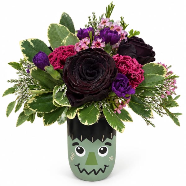 Dark rose bouquet in a Frankenstein-themed vase with purple and pink accents