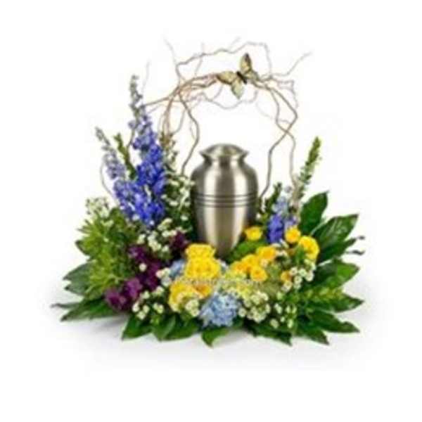 Floral funeral urn arrangement with blue, yellow, and white flowers