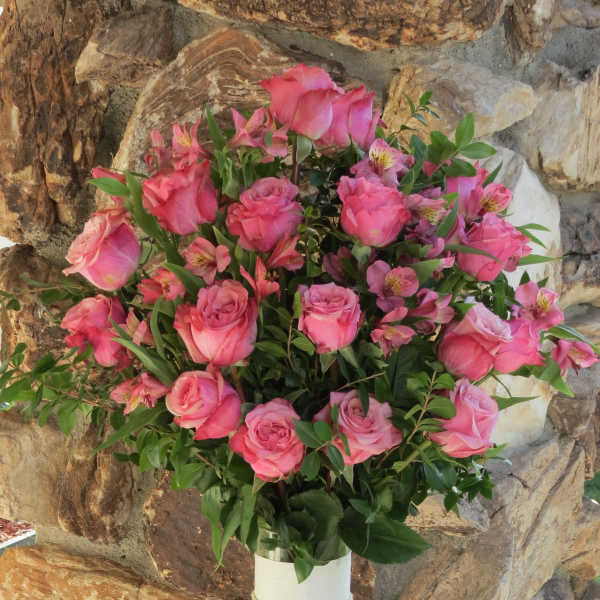 Pink roses and alstroemeria in a clear glass vase
