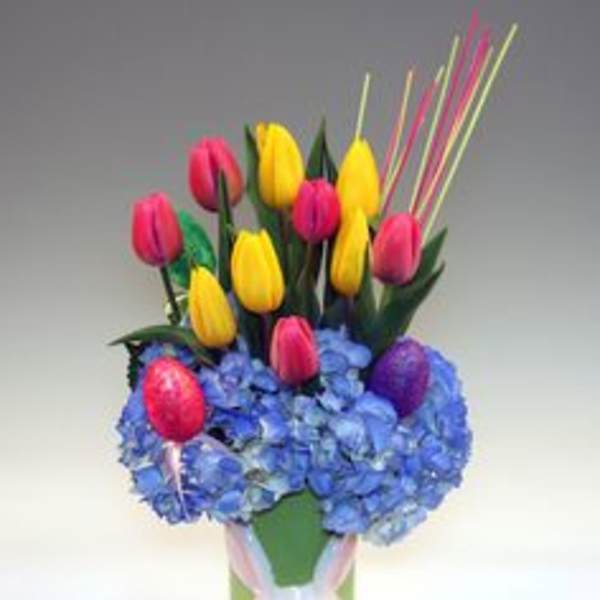 Bouquet of yellow and pink tulips in a bunny-decorated vase