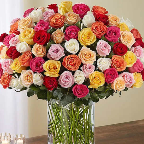 Large bouquet of multicolored roses in a clear glass vase