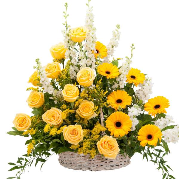 Yellow roses and gerbera daisies in a wicker basket