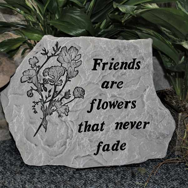 Decorative stone plaque with flowers and the words Friends are flowers that never fade
