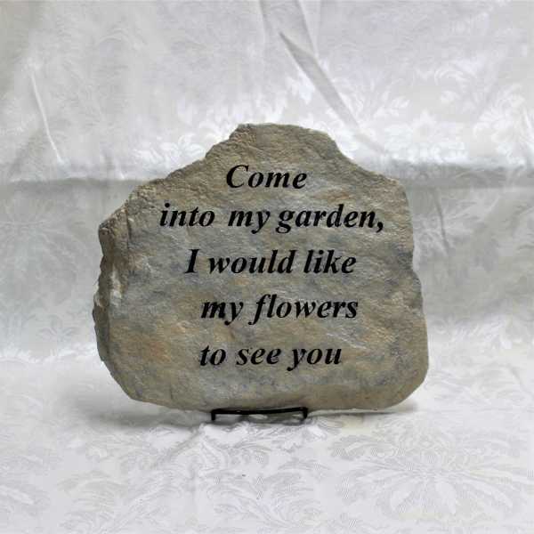 Engraved stone plaque with a garden quote on a stand