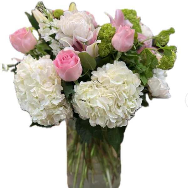 Pink tulips and white hydrangeas in a glass vase