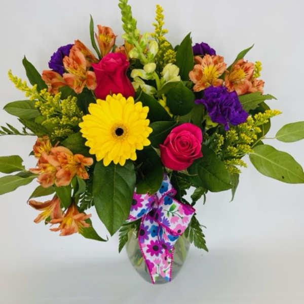 Mixed bouquet with roses, gerbera daisy, and alstroemeria in a glass vase