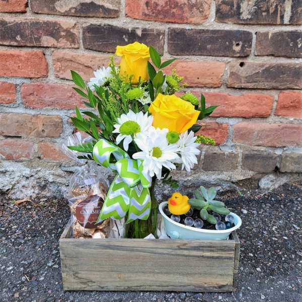Yellow roses and white daisies in a wooden gift box with candy and a small succulent pot