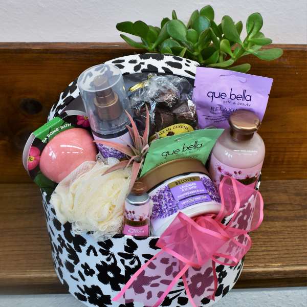 Gift basket with bath products and a small succulent arrangement