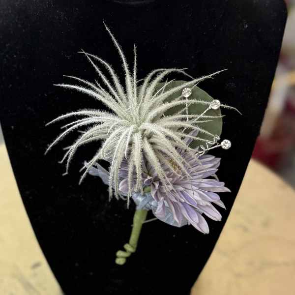 Lavender boutonniere with a white spiky accent on black backing