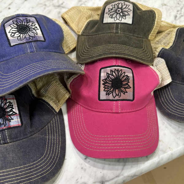 Five embroidered baseball caps in assorted colors with sunflower patches