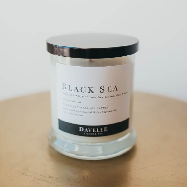 Black Sea candle in a glass jar with a black lid