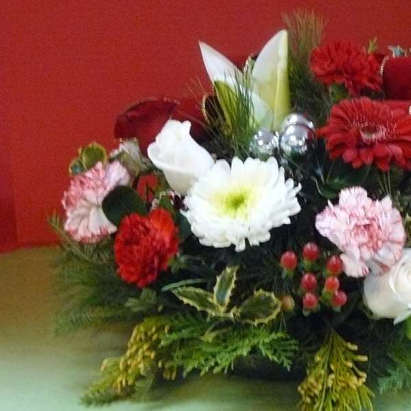 Red, white, and pink floral arrangement with ribbon accents