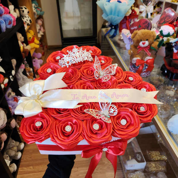 Red rose bouquet in a white box with ribbon and butterfly decorations