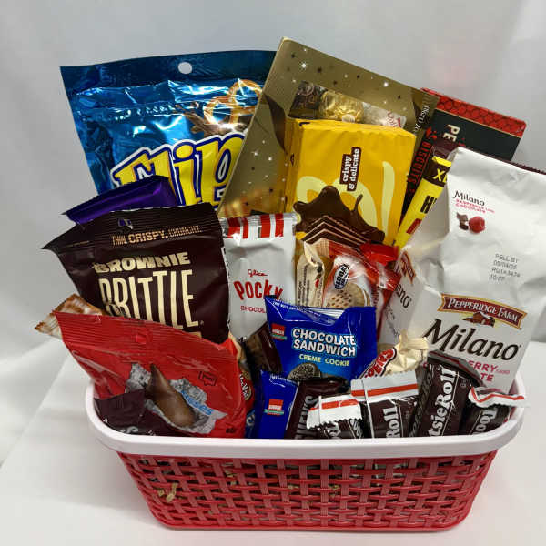 Basket filled with assorted packaged chocolates and cookies