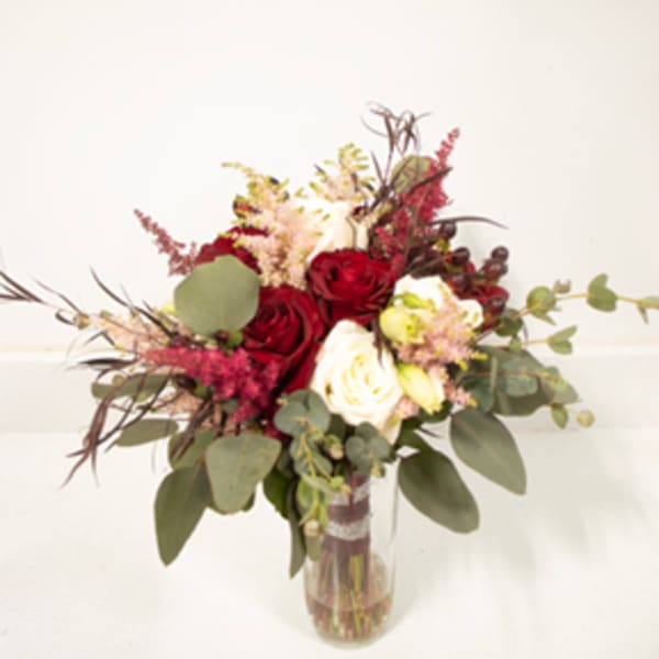 Bouquet of red and white roses in a clear glass vase